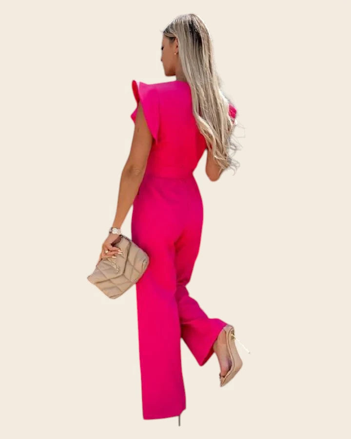 Vue de dos de la combinaison femme chic mariage rose fuchsia. Coupe flatteuse et dos fermé élégant.