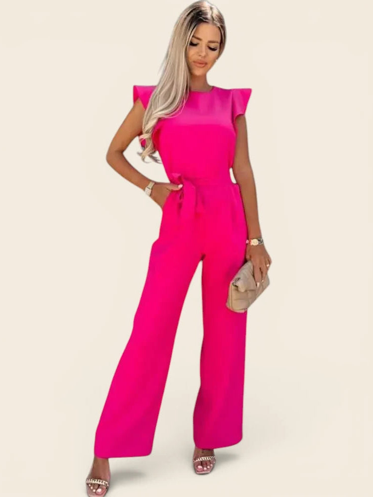 Combinaison femme chic mariage de couleur rose fuchsia. Coupe élégante avec ceinture à nouer et pantalon palazzo.